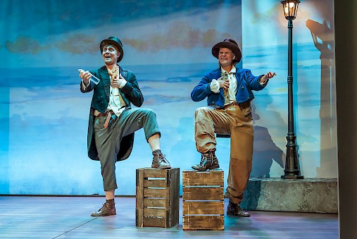 Actors greet audience on stage.